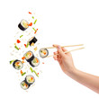 Falling pieces of sushi and sushi roll with wooden chopsticks in female hand