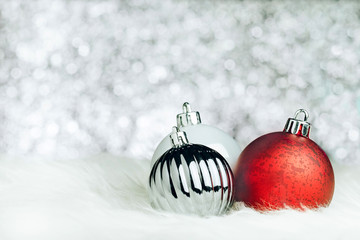 Aufkleber - christmas decoration ball on white fur at silver bokeh light background,holiday greeting card,space 