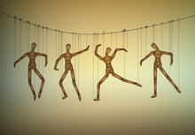 Many Marionette In Different Positions Hanging On The Threats, Manipulate The People Concept,