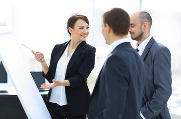 Sticker - business woman showing a business team information on the flipchart