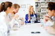 © NDABCREATIVITY - Business people eating in office