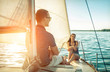 © Andrii IURLOV - Romantic couple in love on sail boat at sunset under sunlight on yacht - Happy exclusive alternative lifestyle concept - Love story of two caucasian young people.