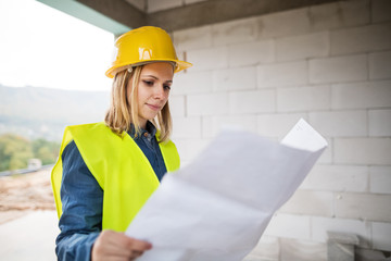 Young woman worker on the building site.