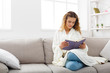 © Prostock-studio - Cozy home. Young thoughtful woman with book