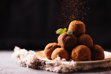 Сhocolate Truffles With Cocoa Powder On White Dessert Plate