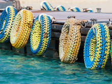 A Number Of Colorful Tires Used On The Pier As Bumpers For Boats