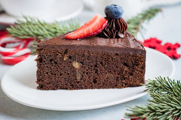 Wall Mural - Christmas Cake for Dessert. Delicious Piece of chocolate cake with cup of coffee and milk on blue stone concrete table background. Breakfast food concept. Festive Holiday Decoration