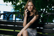 © SHOTPRIME STUDIO - beautiful girl in the park on the bench talking on the phone