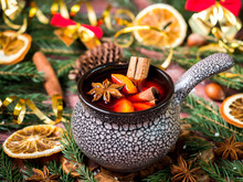 Christmas Mulled Wine With Cinnamon, Orange And Star Anise In A Ceramic Bowl With Winter Decorations