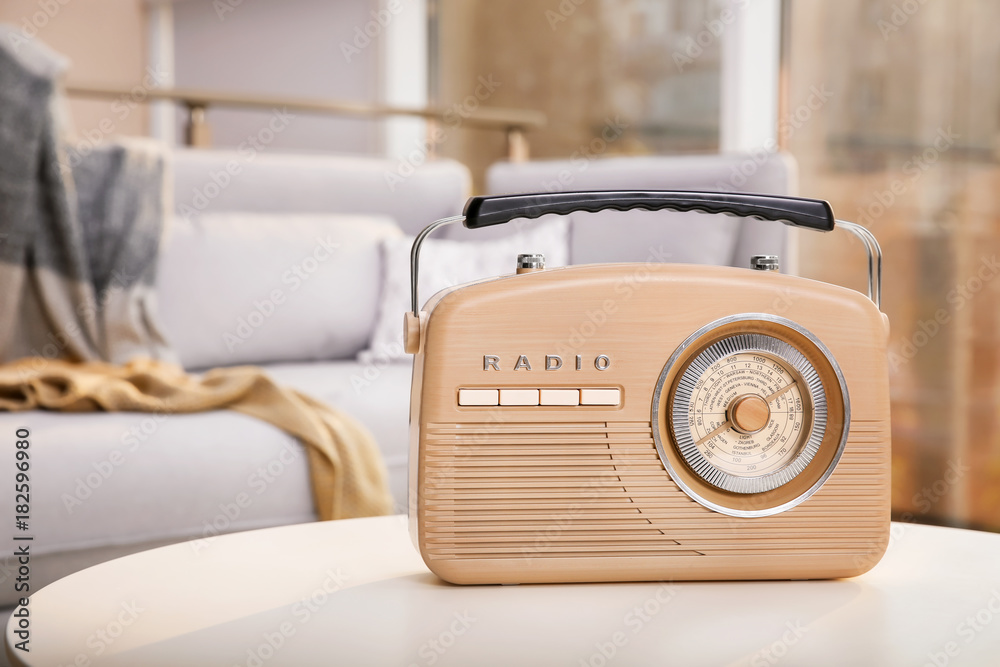 Retro style radio on table indoors