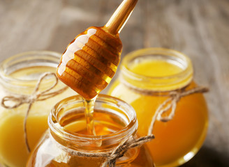 Sticker - Pouring aromatic honey into jar, closeup