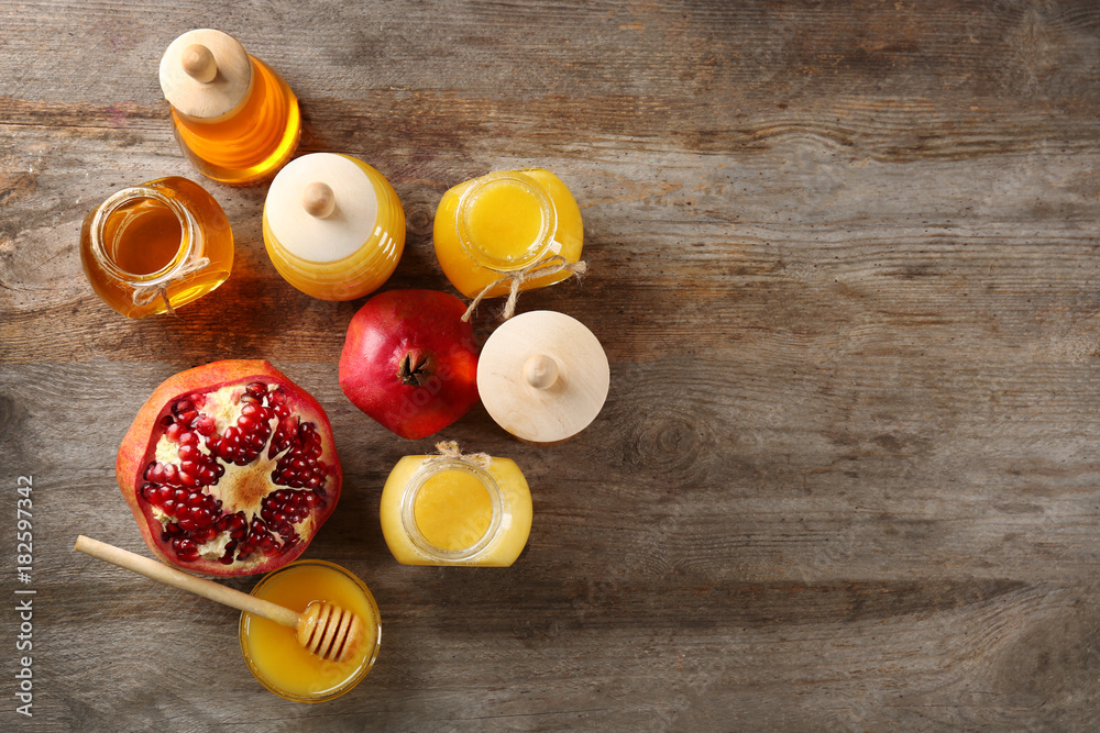 Composition with honey and fruit on wooden background