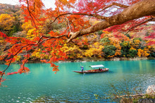 Boatman Punting The Boat At River. Arashiyama In Autumn Season Along The River In Kyoto, Japan.