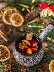 Wall Mural - Christmas mulled wine with cinnamon, orange and star anise in a ceramic bowl with winter decorations