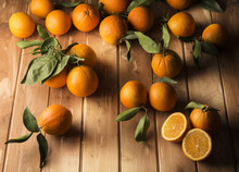 Oranges With Leaves On The Wooden Table