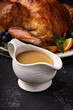 Homemade gravy in a sauce dish with turkey