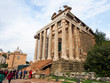 Tourists surrounding the Temple of Antoninus and Faustina in the Roman Forum in Rome Italy.