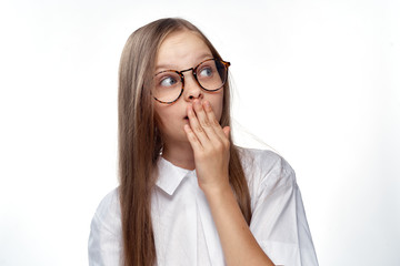 Wall Mural - a girl in a white shirt and glasses is surprised