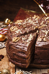 Wall Mural - Cut a piece of Christmas chocolate walnut cake, selective focus