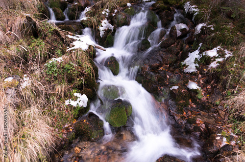 Fast mountain brook rushing through the boulders (long exposure) Poster
