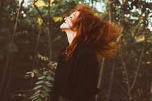 Redhead Woman Waving With Hair On Nature