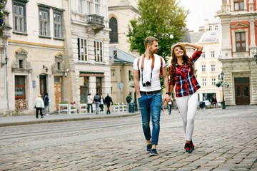 Beautiful Tourist Couple In Love Walking On Street Together.