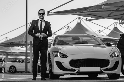 Successful yang businessman in yellow cabrio car. Poster