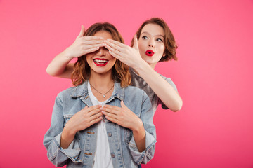 Poster - Two women friends covering eyes with hands.