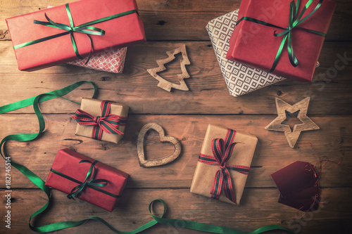 Fotografie, Obraz christmas gifts and decorations on brown wooden background