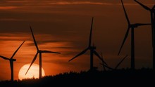 A time-lapse of windmills around sunset
