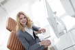 © ASDF - smiling business woman sitting behind a Desk