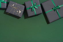 Christmas Gifts On Dark Green Background With Copy Space, Flat Lay
