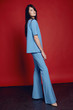 © EVGENY FREEONE - Woman in flared blue trousers