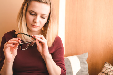 Attractive blond hair girl touching glasses