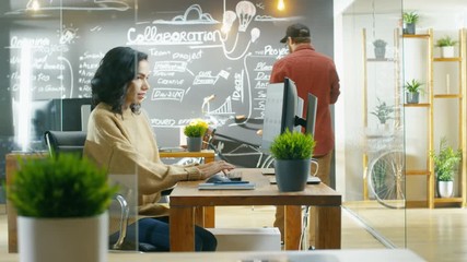 Poster - Beautiful Woman Developer Works on Her Personal Computer. Her Coworkers Talk in the Background. Shot on RED EPIC-W 8K Helium Cinema Camera.