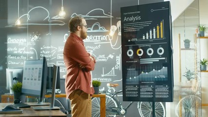 Poster - Marketer Looks at Interactive Touchscreen Whiteboard Showing Latest Graphs and Charts on Statistical Growth. He Works in the Creative Office. Shot on RED EPIC-W 8K Helium Cinema Camera.