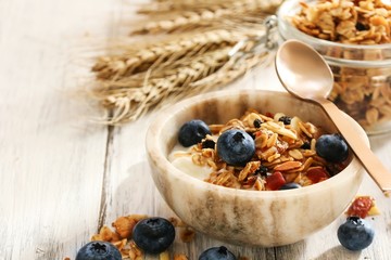 Wall Mural - Granola Yogurt Breakfast Bowl with berries / Health wellness concept, selective focus