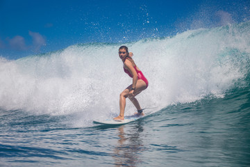 Wall Mural - indonesia, bali, july 23 2016: a female surfer, leonor fragoso riding big blue ocean surfing wave, s
