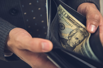 A man opening wallet looking for some money