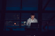 © kanashkin - Businessman working on laptop in night office.