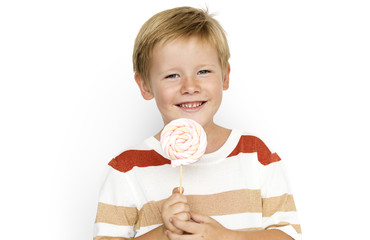 A boys is holding a candy