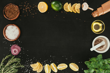 Wall Mural - top view of various spices and seasonings on black with copy space