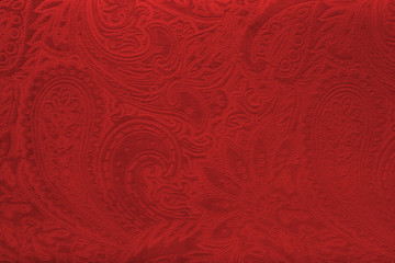 Red velvet fabric with a vintage elegant floral pattern or a luxury texture.