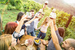 Young friends having fun outdoors drinking red wine glasses - Happy people eating seasonal local food at harvest time in farmhouse vineyard winery - Youth friendship concept on warm vintage filter