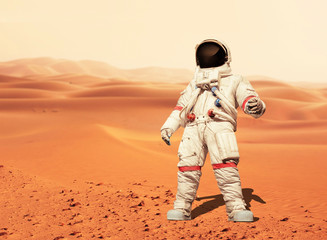 Poster - Man in a space suit standing on the red planet Mars. Spaceman conquer a new planet. Concept of the space