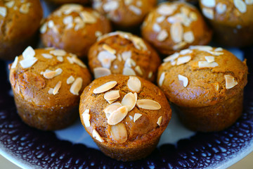 Wall Mural - Platter of homemade vegan pumpkin muffins with almonds