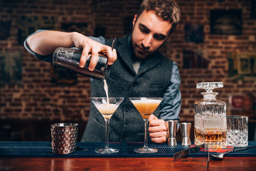 Wall Mural - Barman creating professional cocktails. Details of alcoholic drinks and beverages at pub or bar