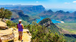 Senior woman enjoying the view of the Blyde River Canyon and Blyde River Dam from the viewpoint at the Three Rondavels along the Panorama Route in Mpumalanga Province of South Africa