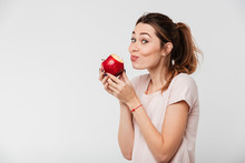 Close Up Portrait Of A Lovely Girl Biting An Apple