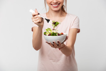 Poster - Portrait of a happy pretty girl eating fresh salad